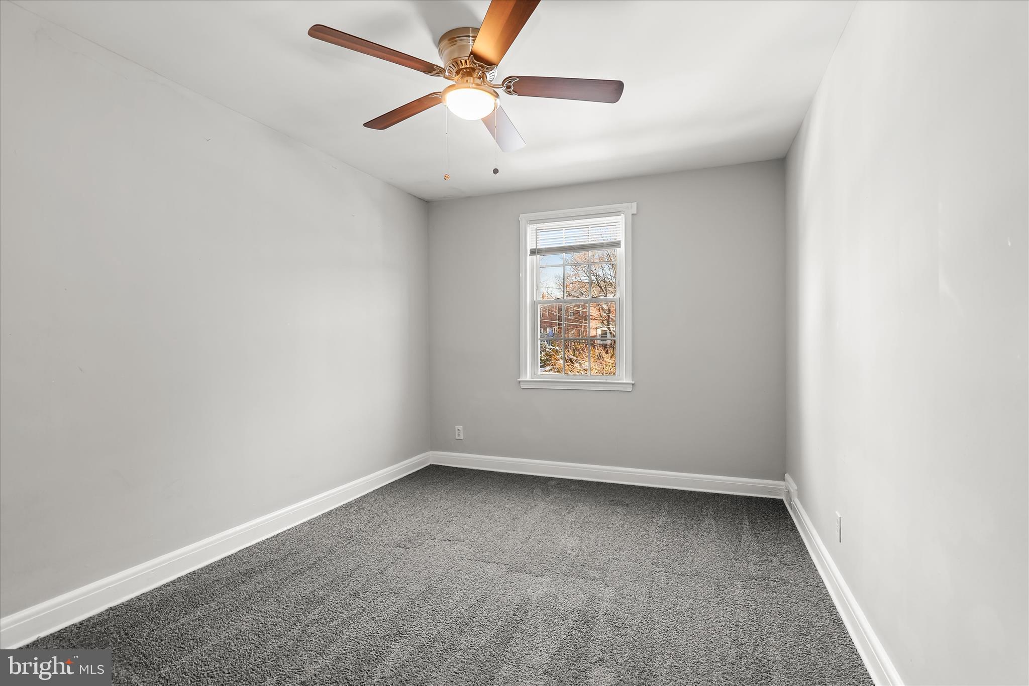 1945 Edgewood Road Towson, MD 21286 - Photo 23 of 46 an empty room with a window and a fan