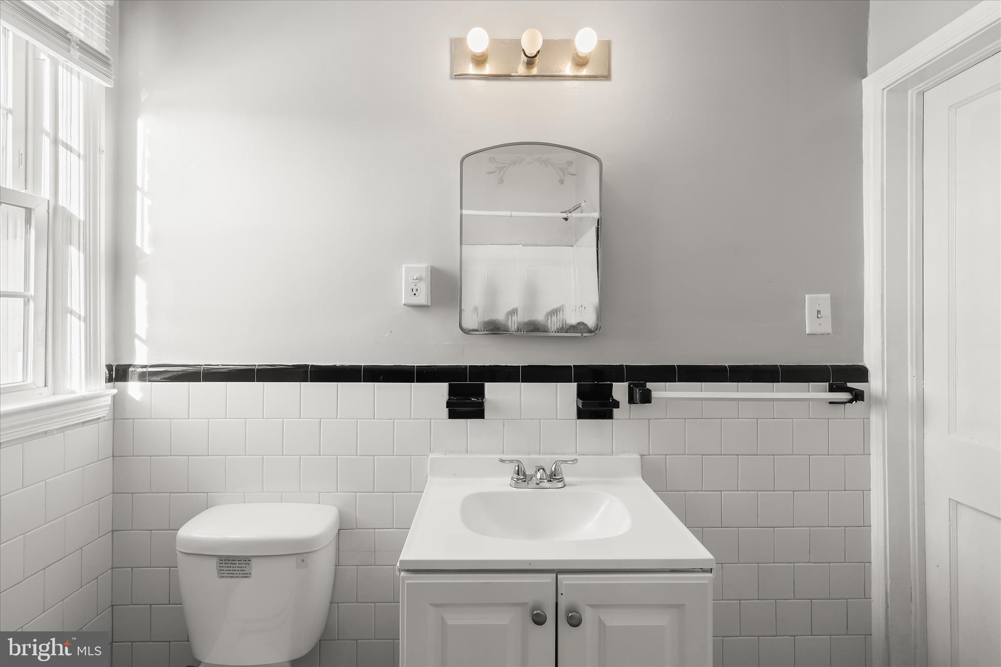 1945 Edgewood Road Towson, MD 21286 - Photo 28 of 46 a bathroom with a toilet sink and mirror