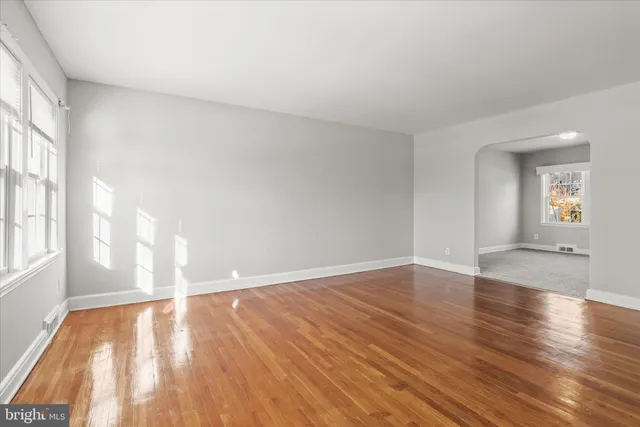 wooden floor in an empty room with a window