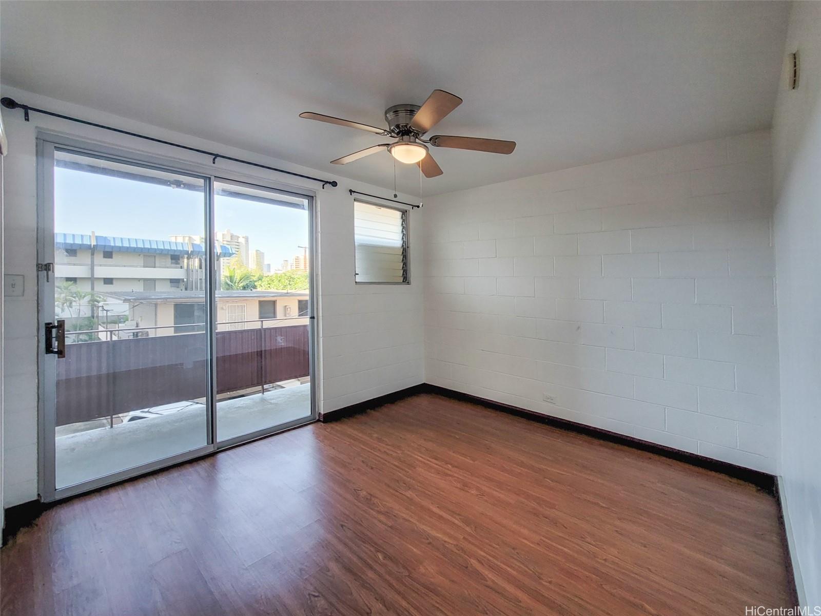 1555 Pensacola Street, Unit 302 Honolulu, HI 96822 - Photo 5 of 11 a view of an empty room with glass door