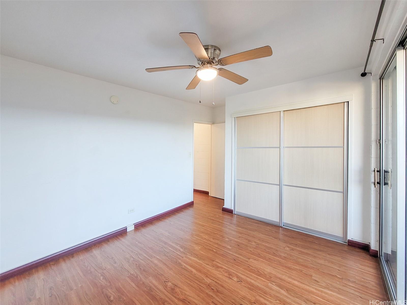 1555 Pensacola Street, Unit 302 Honolulu, HI 96822 - Photo 7 of 11 a view of an empty room with wooden floor