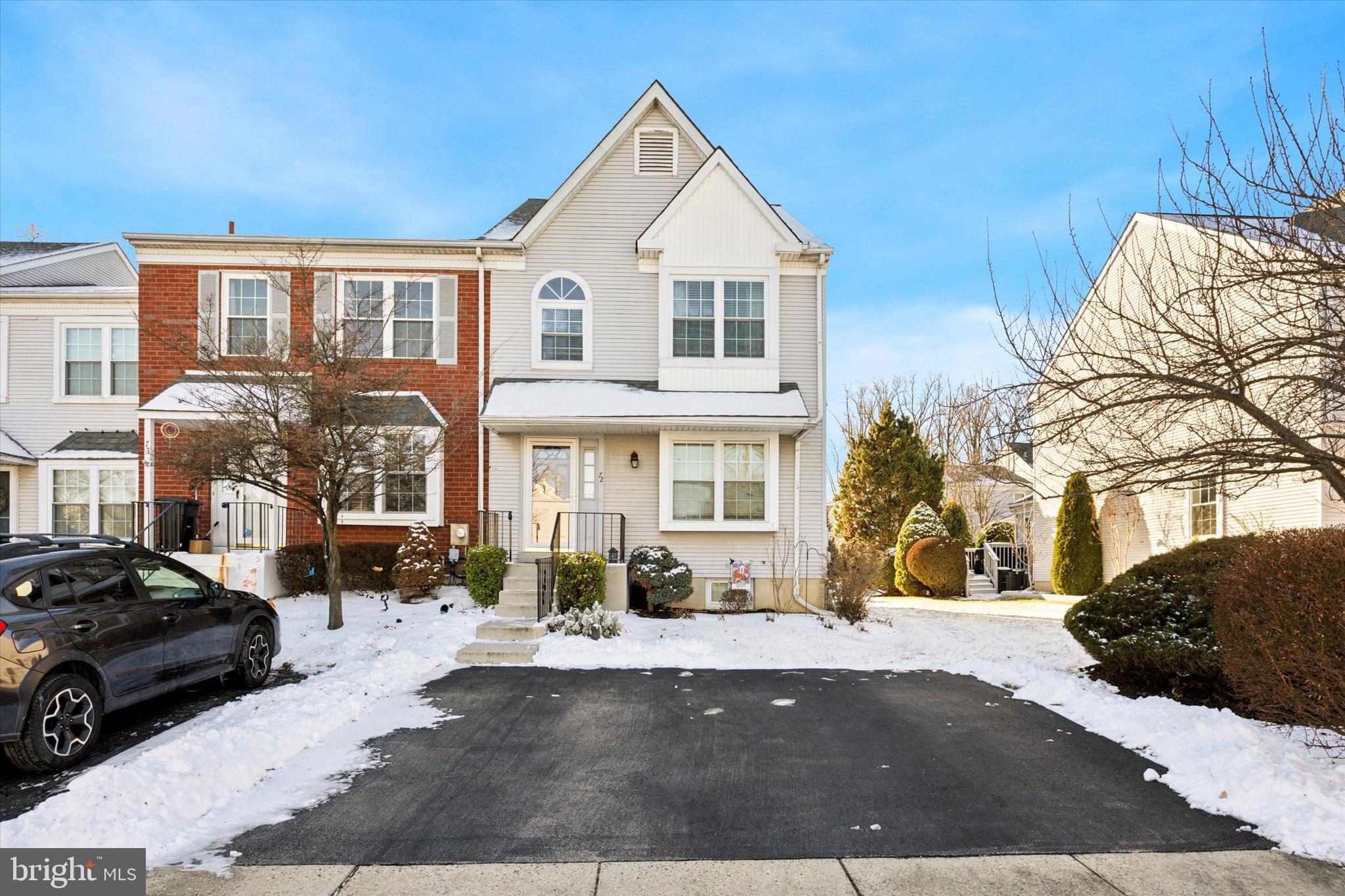 a view of a white house with a yard in front of it