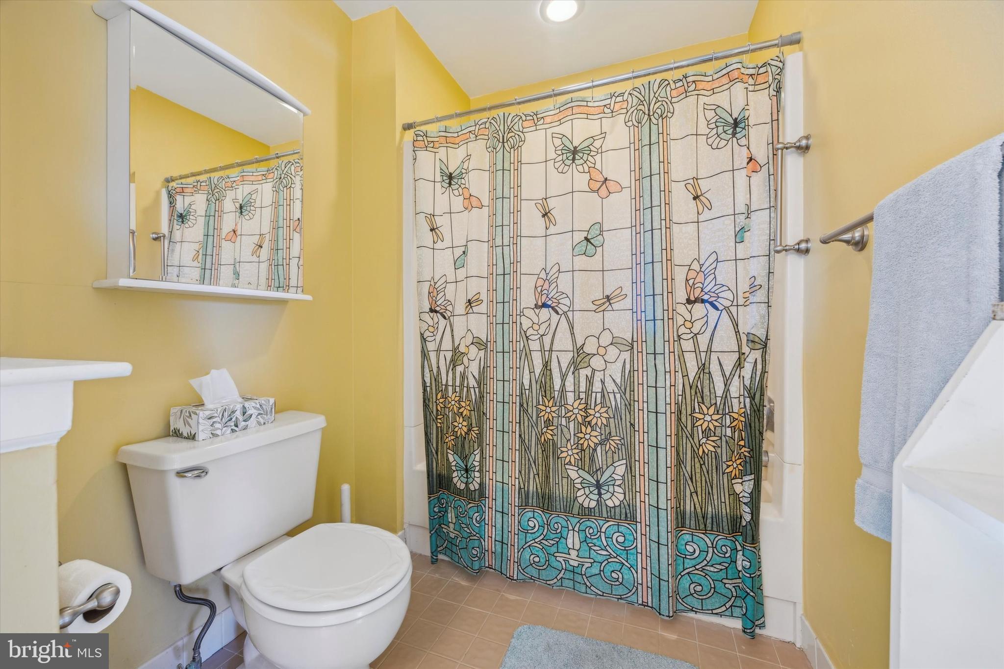 72 Victoria Drive Aston, PA 19014 - Photo 16 of 25 a white toilet sitting next to a shower curtain