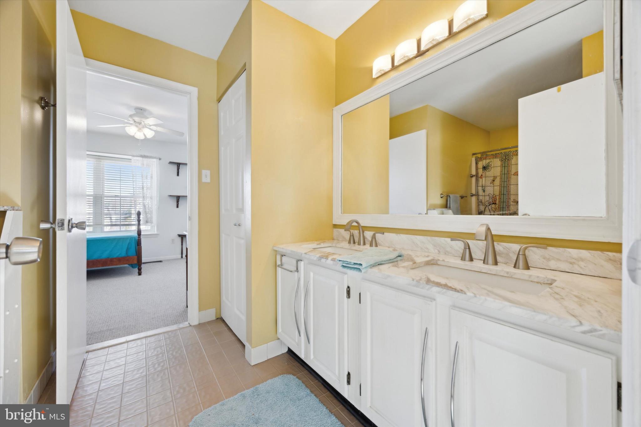 72 Victoria Drive Aston, PA 19014 - Photo 18 of 25 a en suite bathroom with a granite countertop sink and a mirror