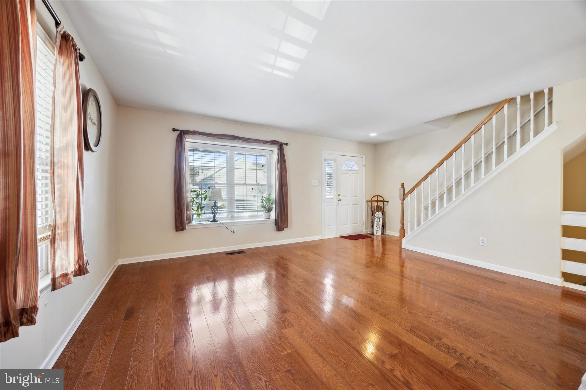72 Victoria Drive Aston, PA 19014 - Photo 5 of 25 a view of an empty room with wooden floor and a window