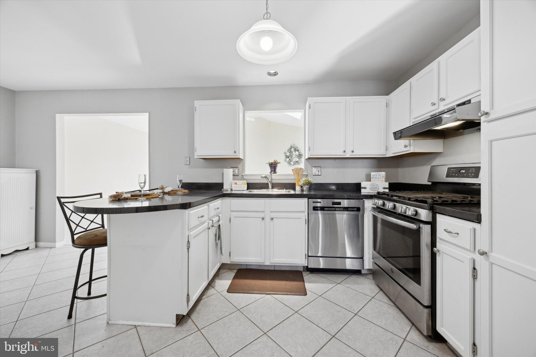 72 Victoria Drive Aston, PA 19014 - Photo 8 of 25 a kitchen with stainless steel appliances granite countertop a sink and cabinets