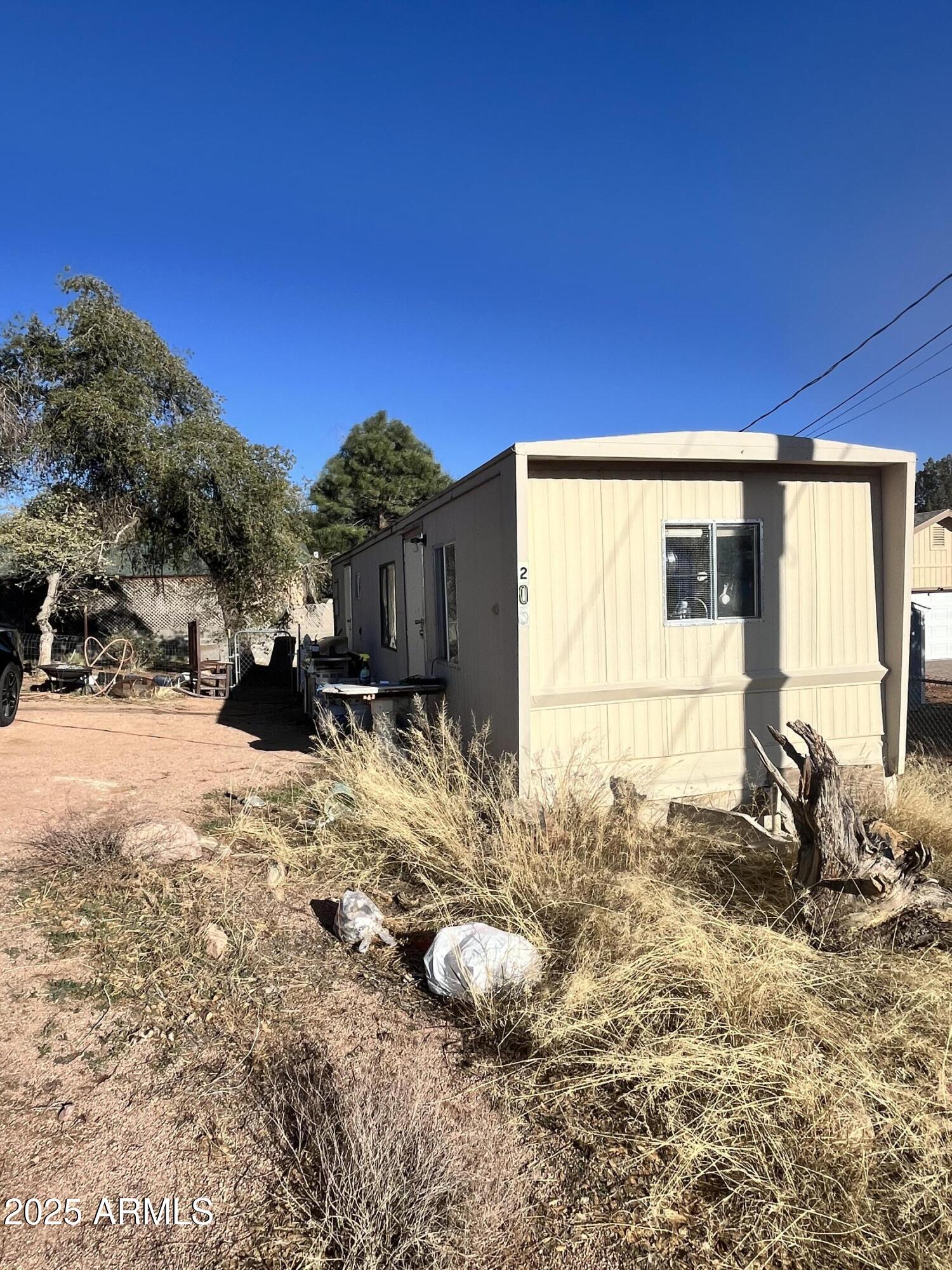 205 South Granite Drive Payson, AZ 85541 - Photo 2 of 5 a backyard of a house with table and chairs under an umbrella