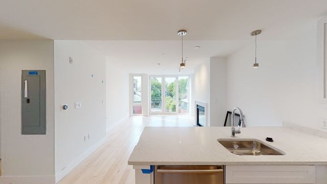 a kitchen with a sink a window and stainless steel appliances