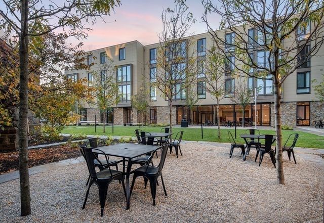 a view of a patio with a table and chairs