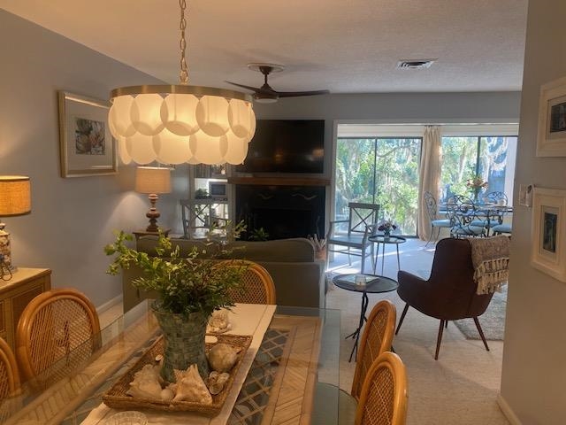 18 Canvasback Cove, Unit 122 Georgetown, SC 29440 - Photo 8 of 32 Dining area featuring ceiling fan and a fireplace