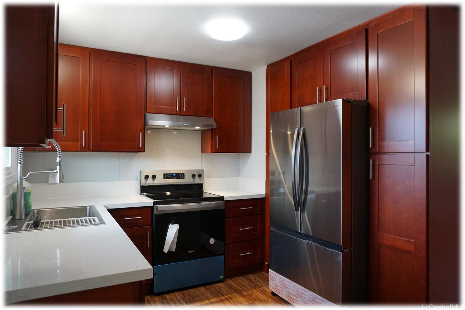 a kitchen with a refrigerator and a stove