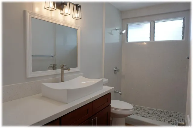 a bathroom with a sink toilet and a mirror