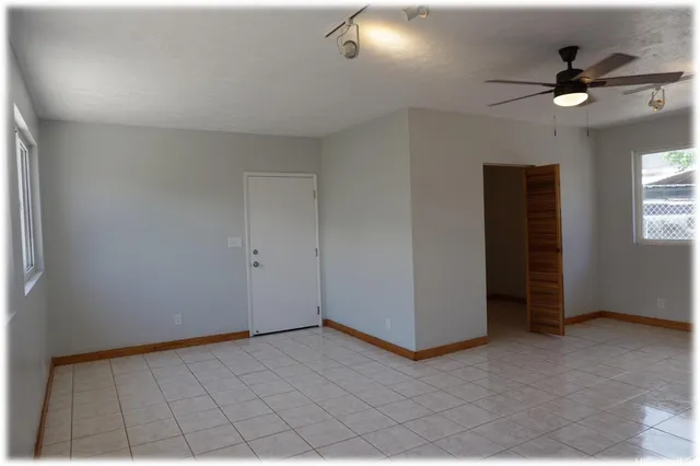 a view of a livingroom with a ceiling fan and window
