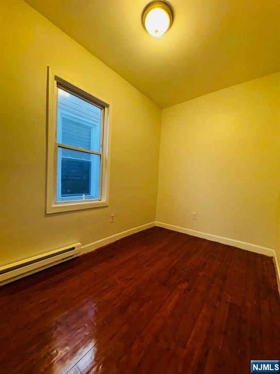 489 South 17th Street, Unit 1 Newark, NJ 07103 - Photo 6 of 9 a view of a room with wooden floor and brick walls