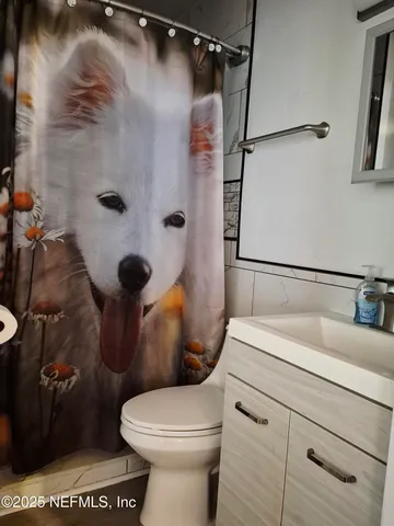 a white toilet sitting next to a bathroom sink
