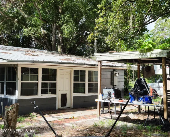 a view of a house with backyard porch and sitting area