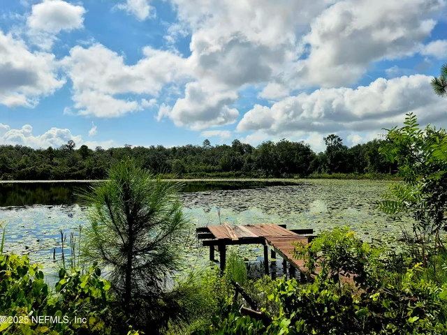 a view of a lake with table and chairs
