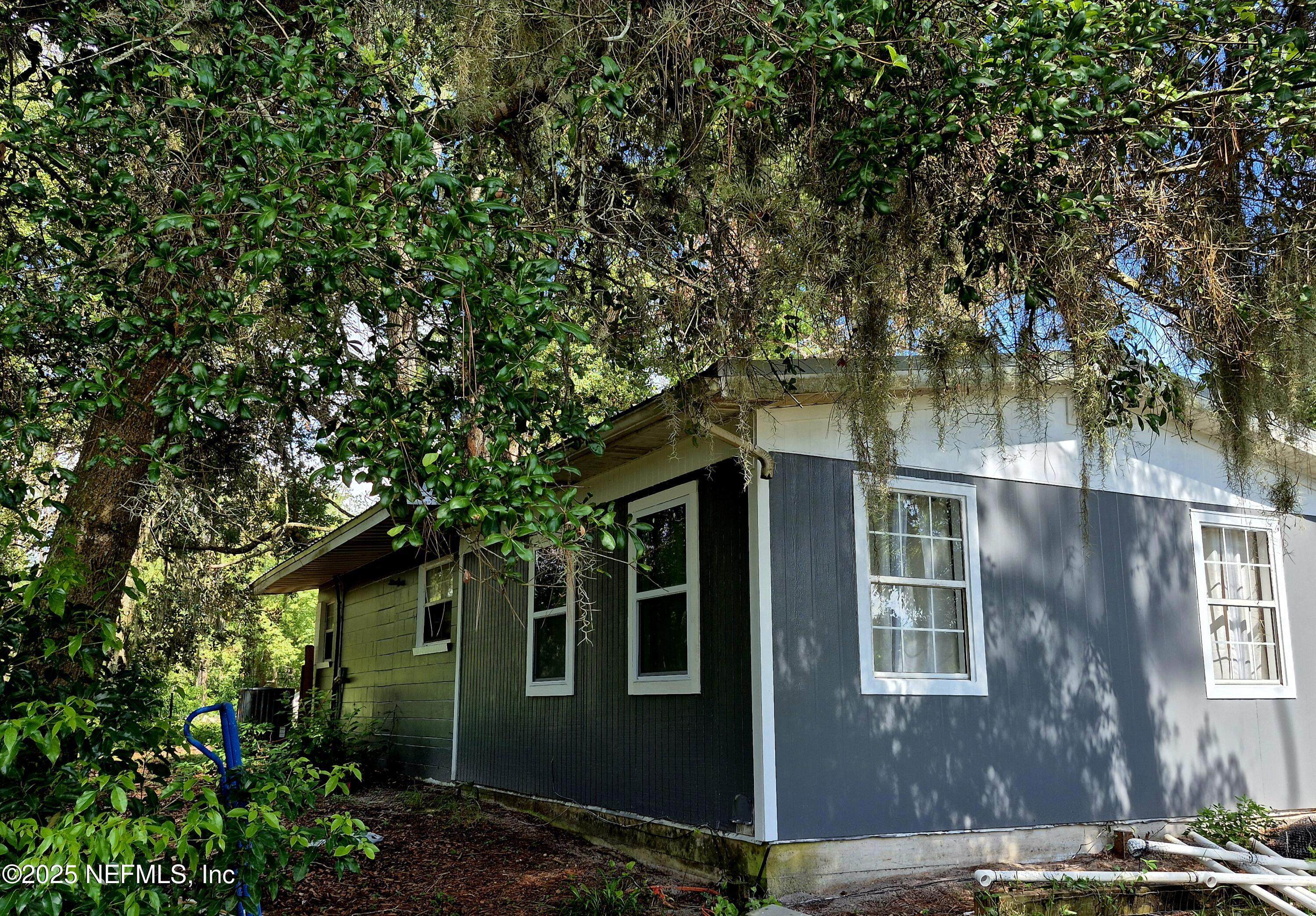 282 Byrd Road Crescent City, FL 32112 - Photo 6 of 24 a view of a brick house with large windows and a tree