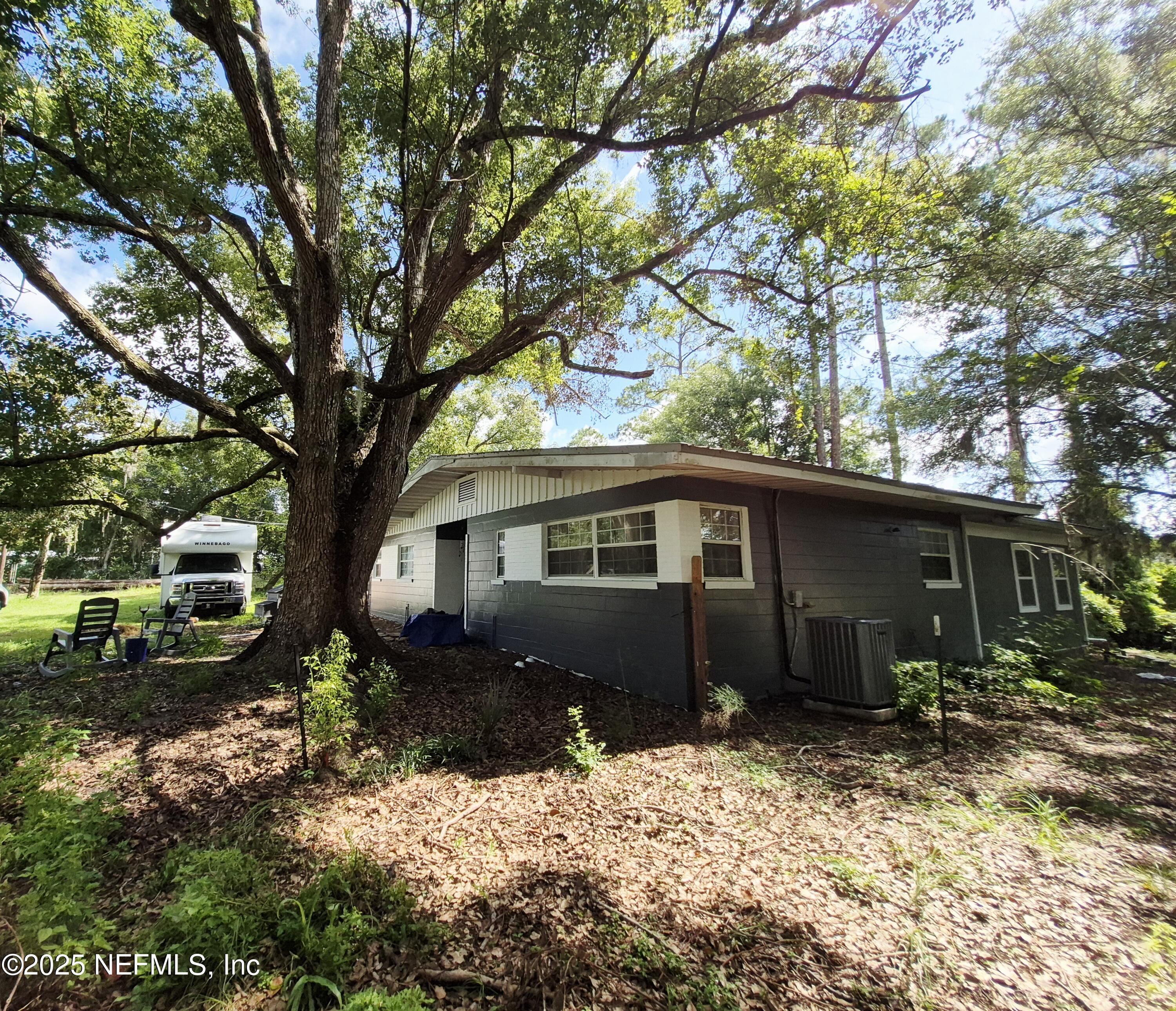 282 Byrd Road Crescent City, FL 32112 - Photo 7 of 24 a backyard of a house with yard and outdoor seating