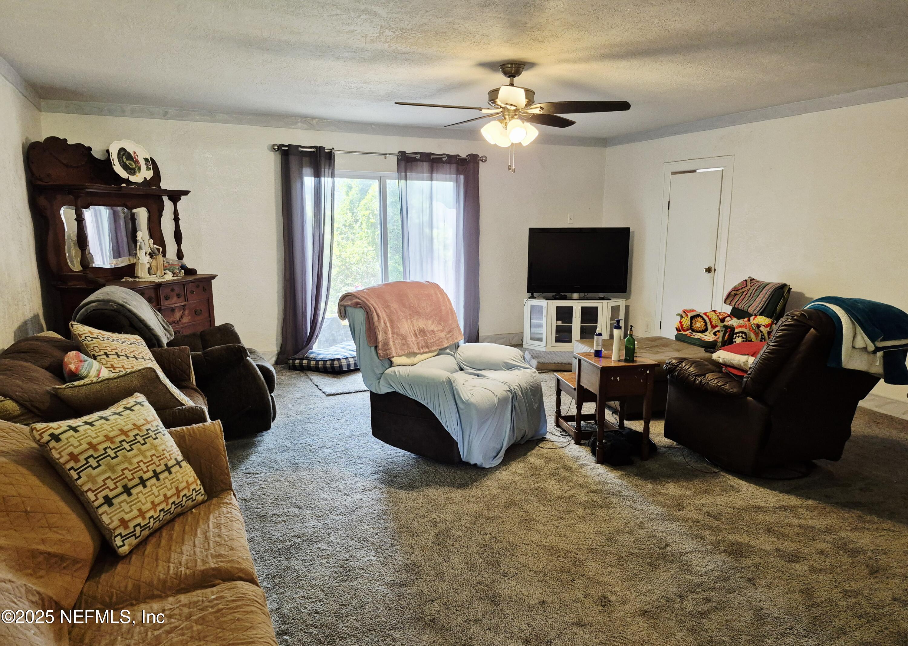 282 Byrd Road Crescent City, FL 32112 - Photo 9 of 24 a living room with furniture and a flat screen tv