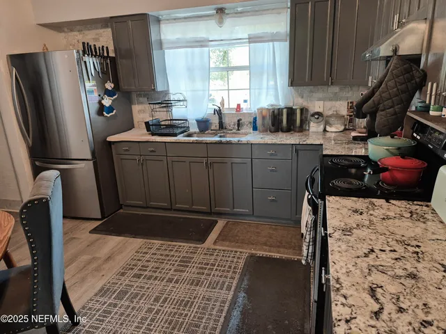 a kitchen with a sink stove and refrigerator