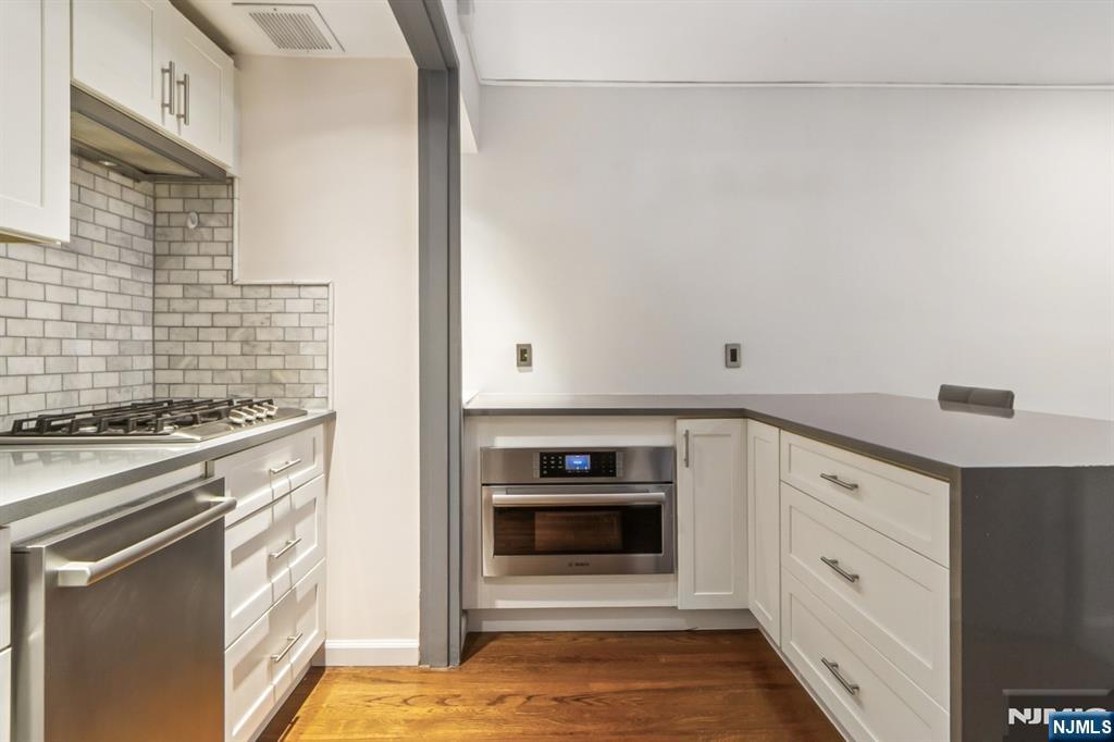 3050 Edwin Avenue, Unit 2D Fort Lee, NJ 07024 - Photo 8 of 21 a kitchen with stainless steel appliances granite countertop a stove and a refrigerator