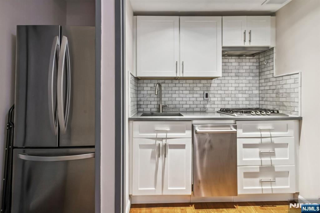3050 Edwin Avenue, Unit 2D Fort Lee, NJ 07024 - Photo 9 of 21 a kitchen with stainless steel appliances granite countertop a refrigerator and a sink