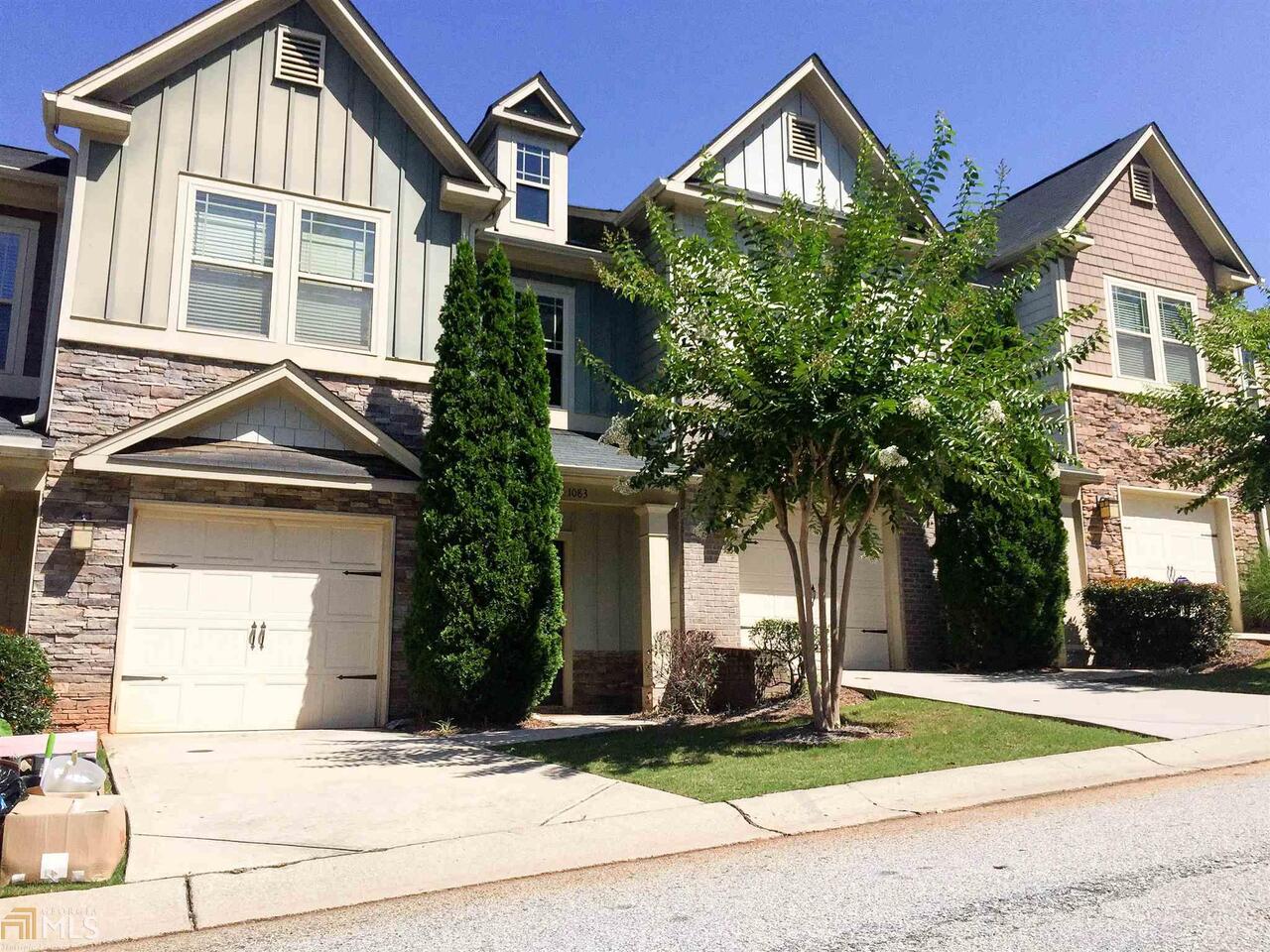 1083 North Village Drive Decatur, GA 30032 - Photo 1 of 1 a front view of a house with a yard and garage