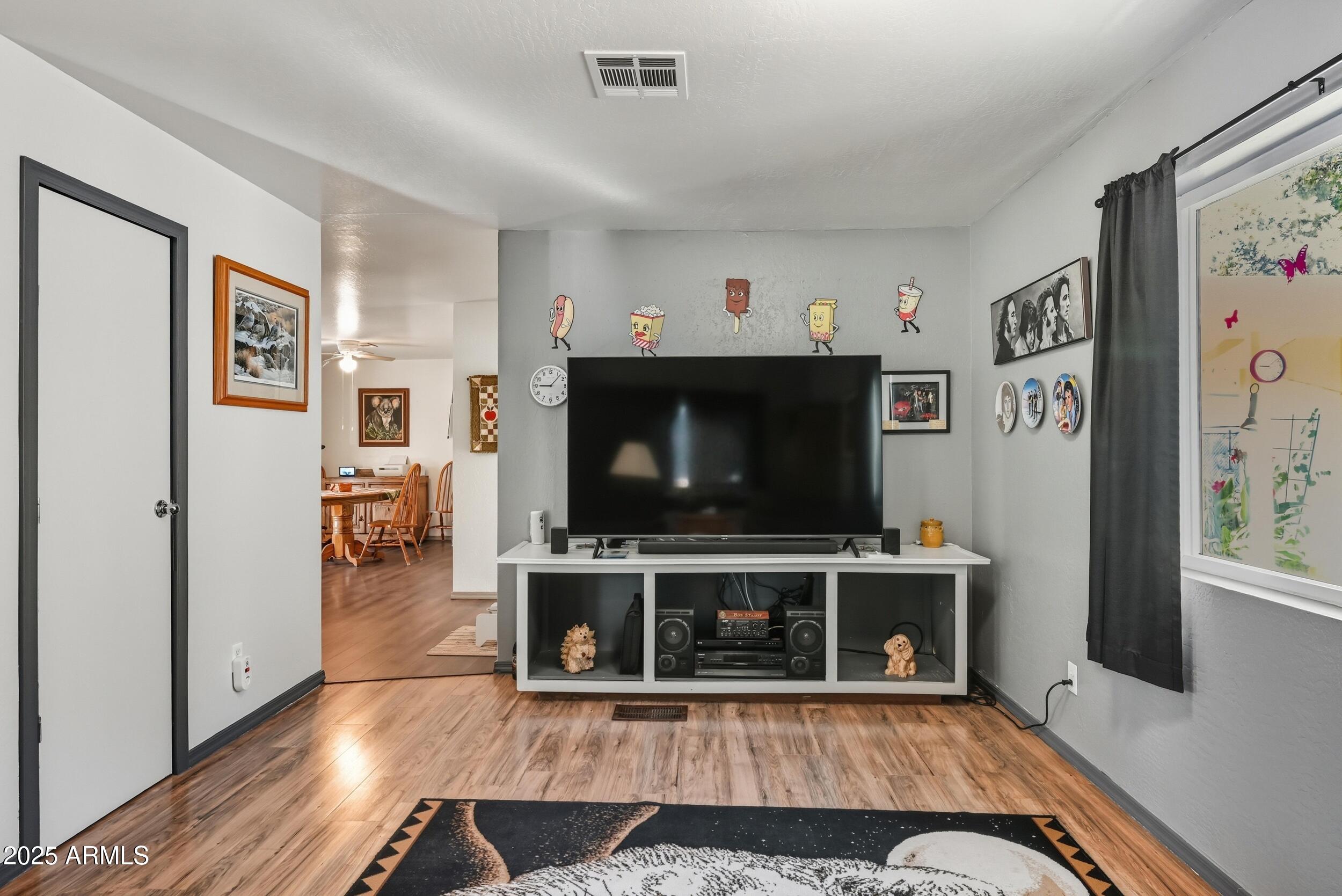 500 East Lorene Street Payson, AZ 85541 - Photo 12 of 41 a living room with furniture a flat screen tv and a fireplace