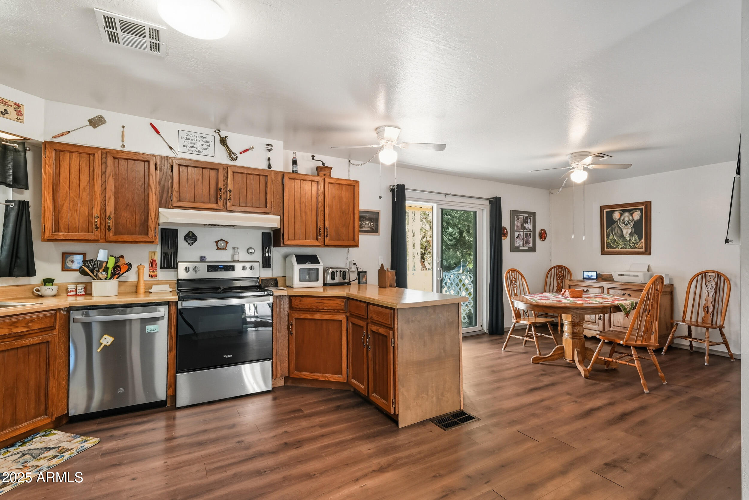 500 East Lorene Street Payson, AZ 85541 - Photo 14 of 41 a kitchen with stainless steel appliances granite countertop a stove top oven a sink dishwasher a dining table and chairs with wooden floor