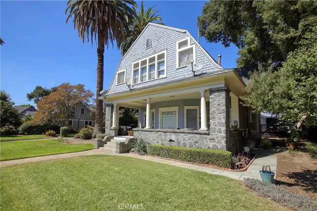 a front view of a house with yard and green space