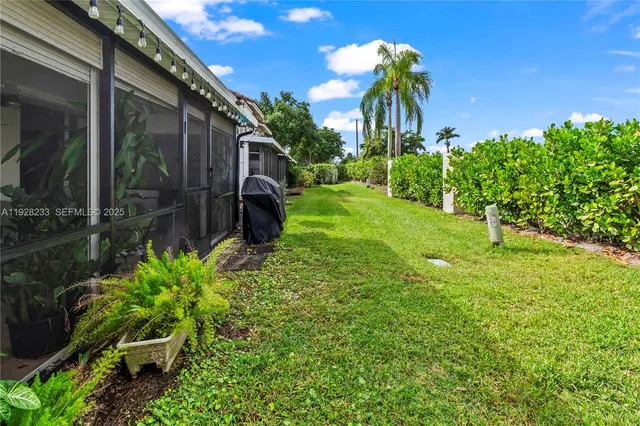 a view of a back yard of the house and a yard