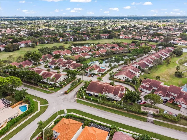 an aerial view of residential houses with outdoor space