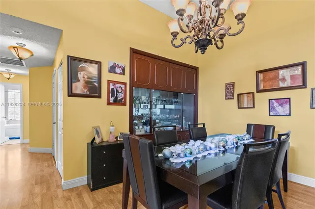 a view of a dining room with furniture and chandelier