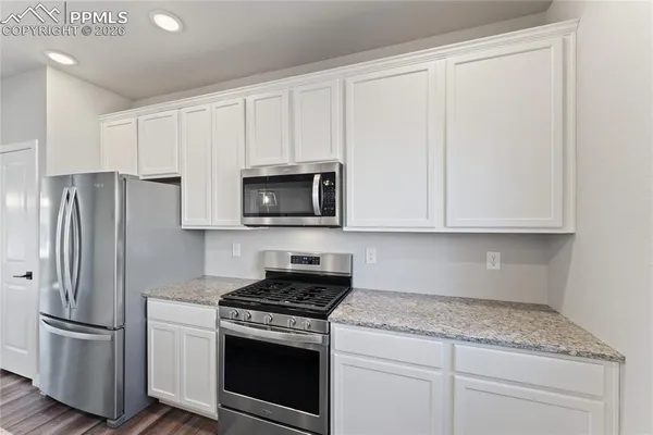 a dining room with furniture a rug and wooden floor