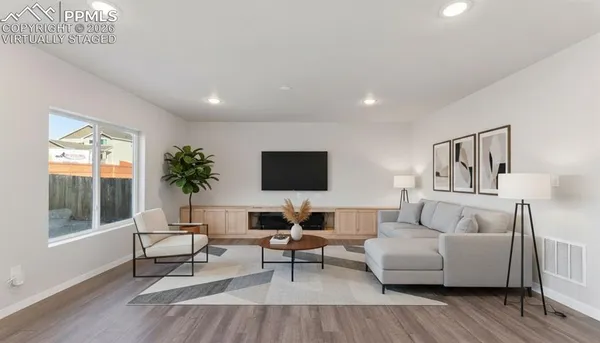a view of empty room with wooden floor