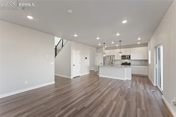 a kitchen with stainless steel appliances granite countertop white cabinets and a granite counter tops