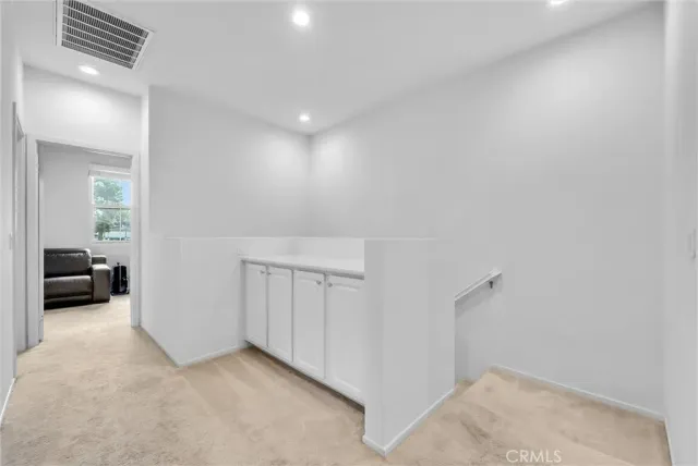 a view of a livingroom with furniture and a hallway