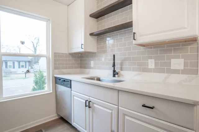 a kitchen with a sink and cabinets