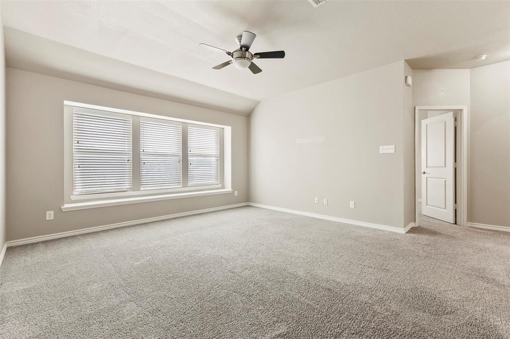 6522 Portside Ridge Lane Dallas, TX 75249 - Photo 17 of 37 Spacious room featuring neutral carpeting, light gray wall paint, and a multi-pane window with blinds