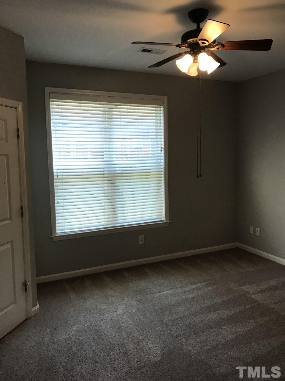 1701 Tiffany Bay Court, Unit 102 Raleigh, NC 27609 - Photo 11 of 13 a view of room window and a ceiling fan