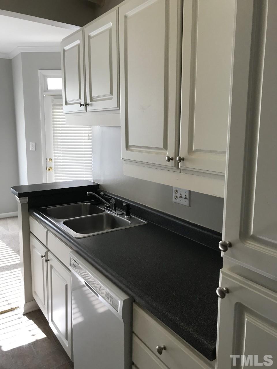 1701 Tiffany Bay Court, Unit 102 Raleigh, NC 27609 - Photo 12 of 13 a kitchen with a sink and cabinets