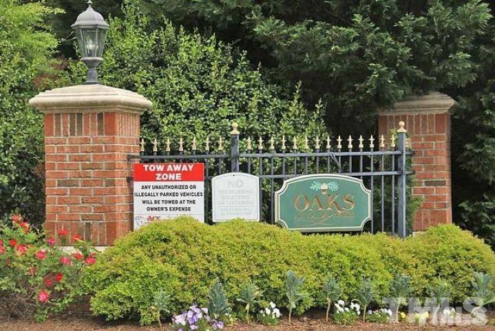 1701 Tiffany Bay Court, Unit 102 Raleigh, NC 27609 - Photo 2 of 13 a sign that is on a brick wall