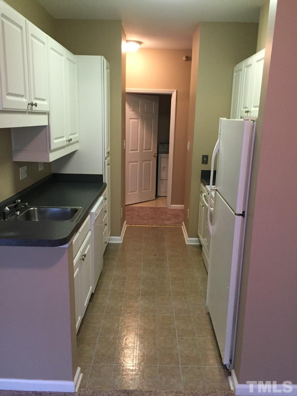 1701 Tiffany Bay Court, Unit 102 Raleigh, NC 27609 - Photo 3 of 13 a kitchen with a refrigerator and a stove