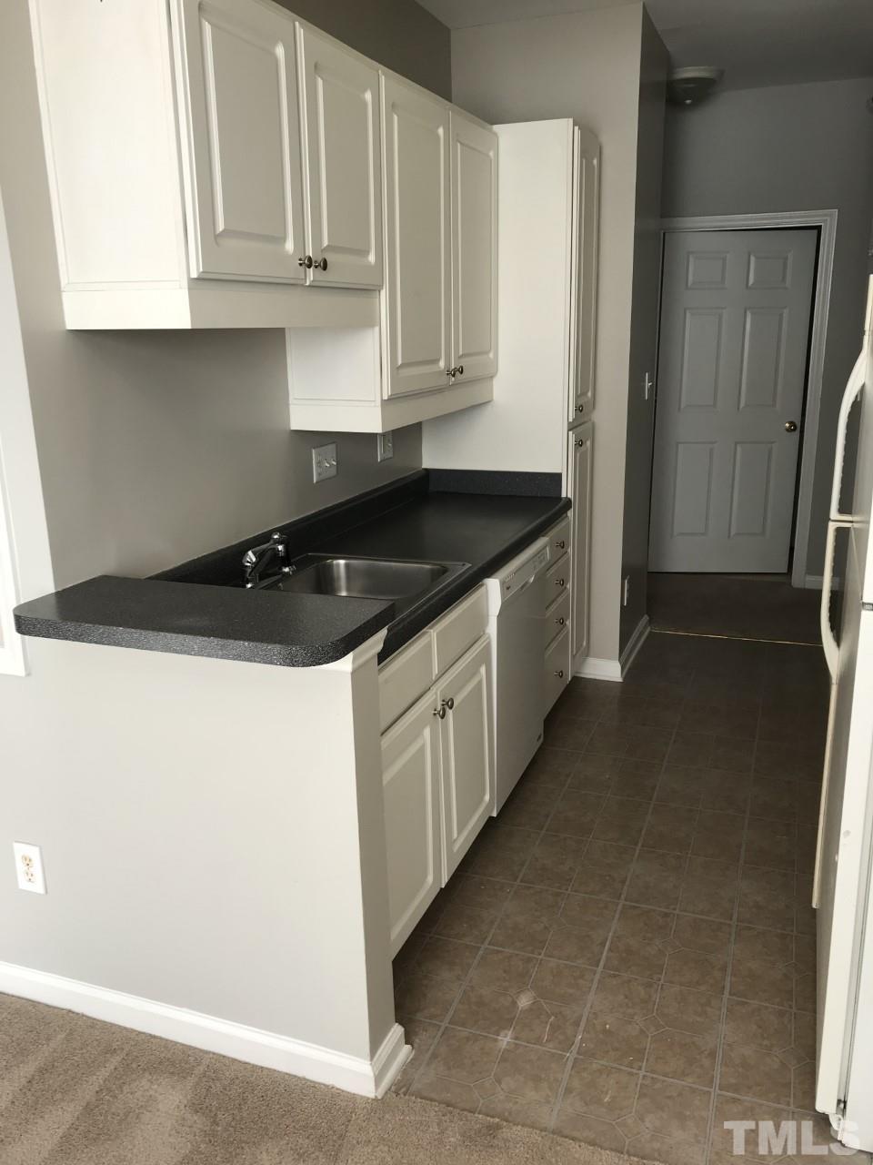1701 Tiffany Bay Court, Unit 102 Raleigh, NC 27609 - Photo 4 of 13 a kitchen with a sink and cabinets