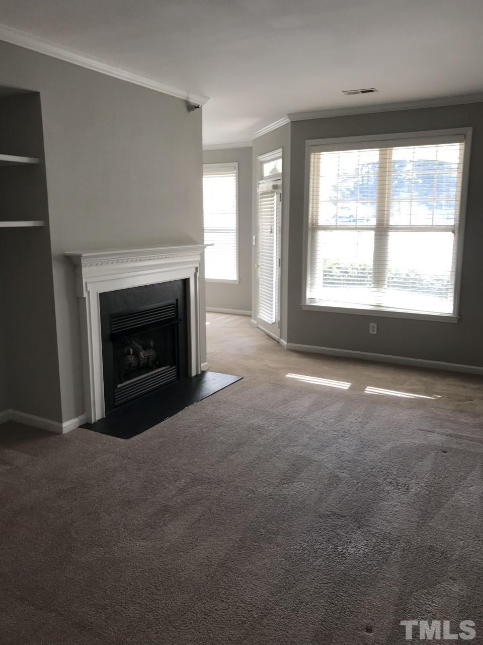 1701 Tiffany Bay Court, Unit 102 Raleigh, NC 27609 - Photo 8 of 13 a view of empty room with a fireplace