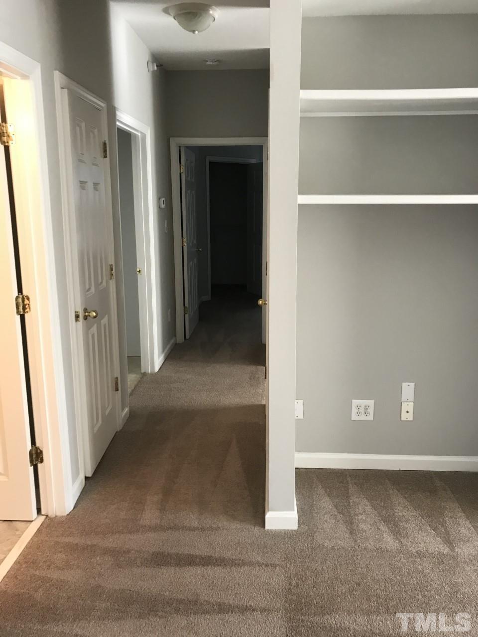 1701 Tiffany Bay Court, Unit 102 Raleigh, NC 27609 - Photo 10 of 13 a view of a hallway with wooden floor