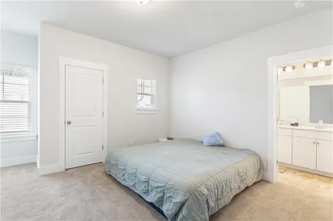 a bedroom with a bed and a sink