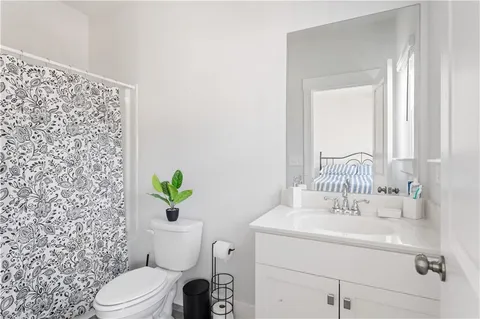 a bathroom with a sink mirror vanity and toilet