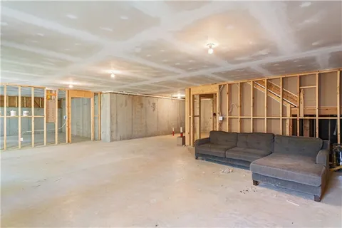 a living room with furniture and a ceiling fan
